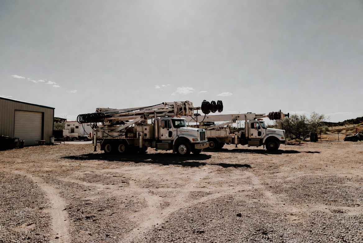 Superior Pro Drilling shop yard with parked rigs at dusk